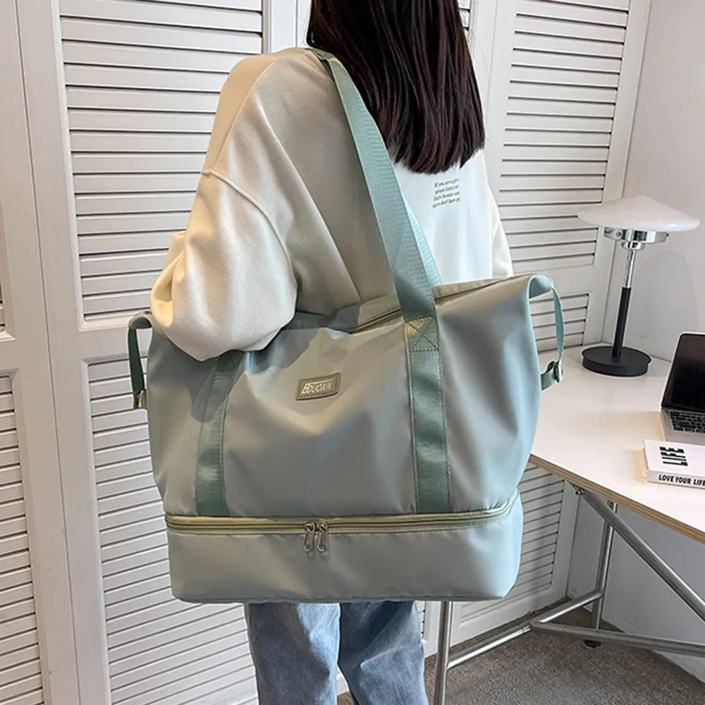 Teal and pale green nylon duffel bag with wide handles and front zipper