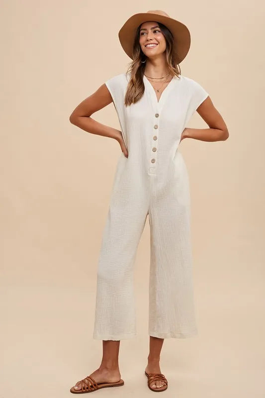 Cream button-front wide-leg jumpsuit with short sleeves and side pockets