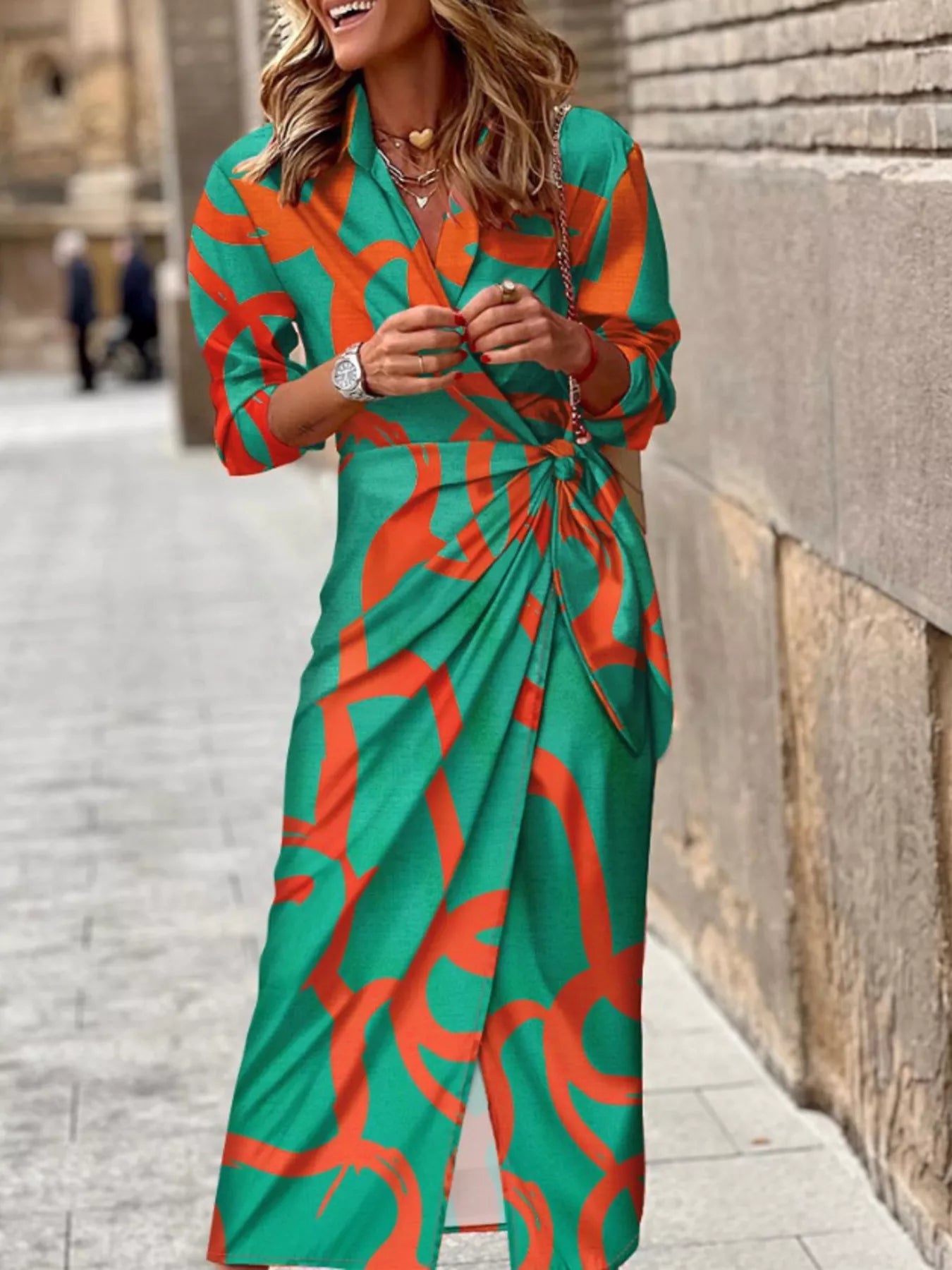 Teal wrap midi dress with orange abstract print, V-neck and tied waist belt
