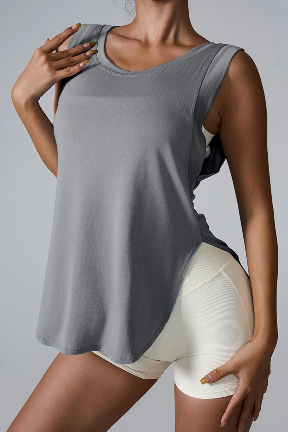 Light gray sleeveless active tank top with round neck and side slit hem