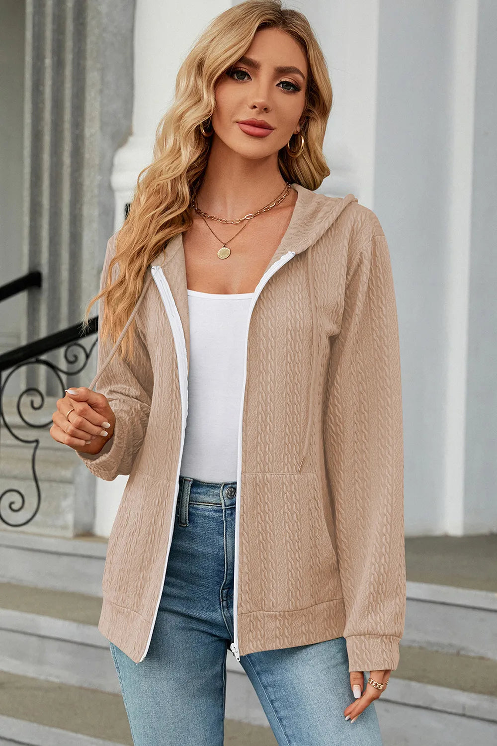 Cream zip-up hoodie with drawstring hood and front zipper, long sleeves