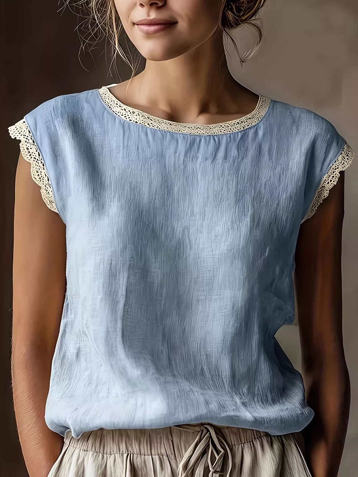 Sky blue sleeveless blouse with lace-trim round neckline and textured fabric