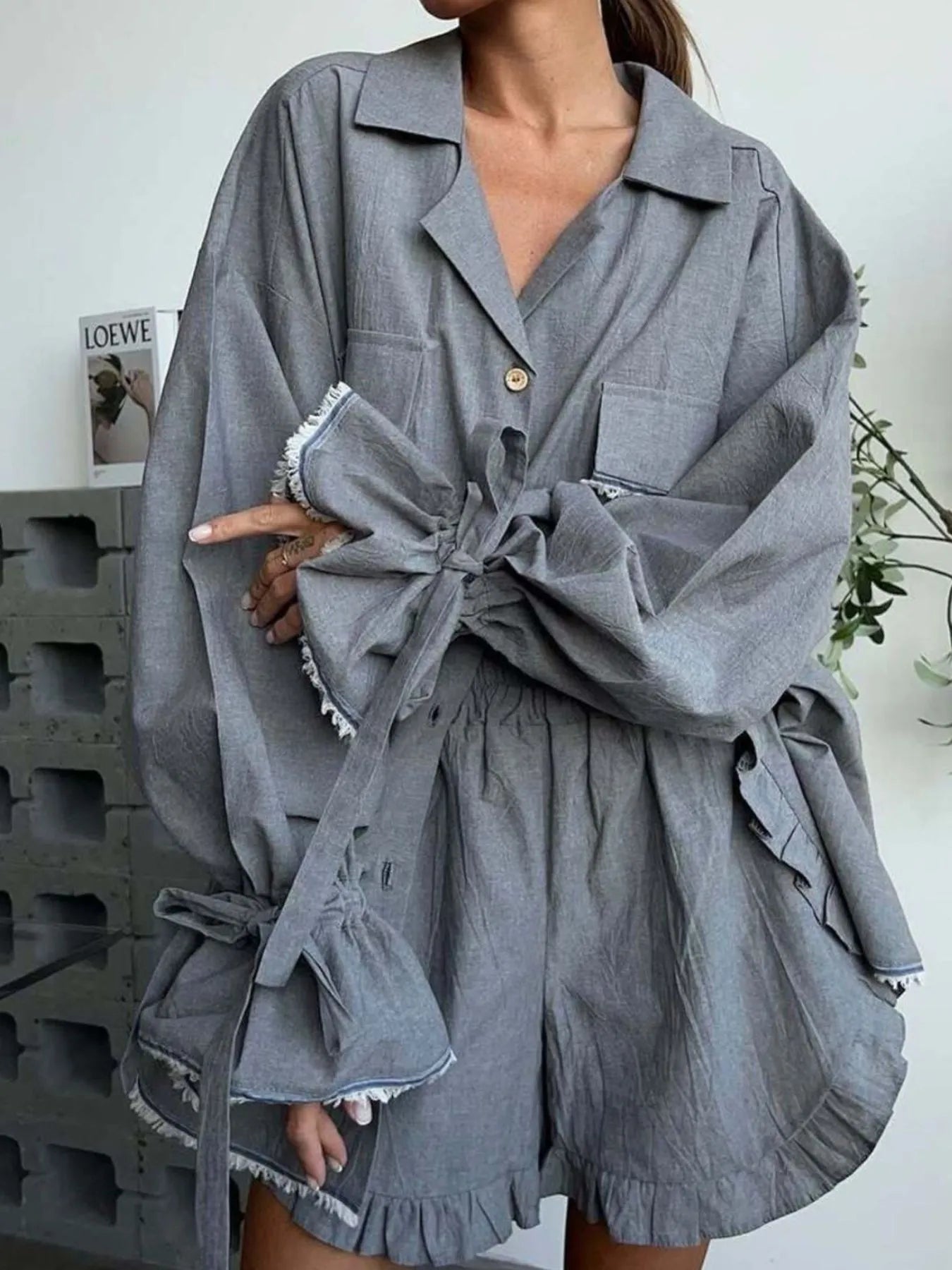 Dark gray button-up top with knotted flounce sleeves and ruffled shorts set