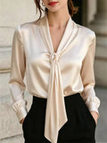 Ivory satin blouse with V-neck and front tie, long sleeves