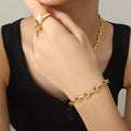 Gold chain bracelet on wrist with oval links and secure clasp.