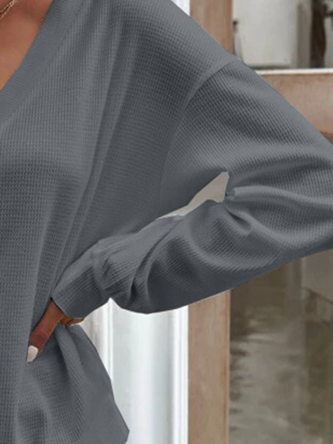Dark gray blouse sleeve detail with loose cuff and soft drape