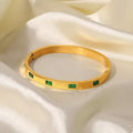 Gold-plated bangle bracelet with green square enamel accents