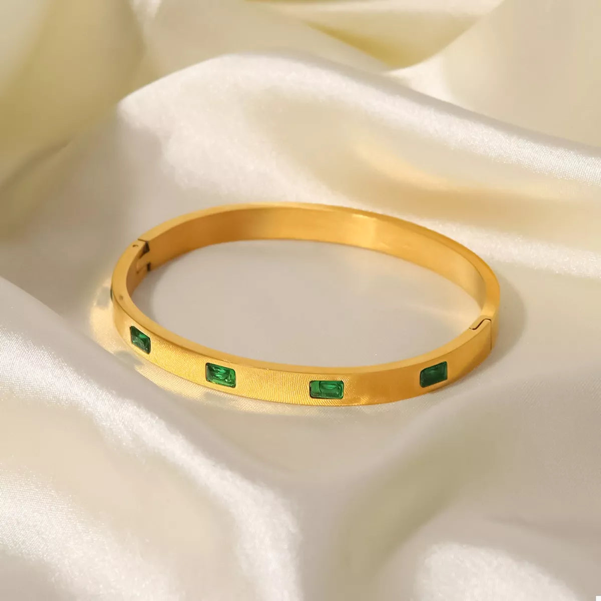 Gold-plated bangle bracelet with green square enamel accents