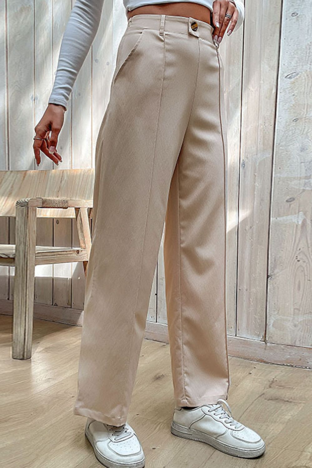 Beige wide-leg center-seam pants with high-rise waist, belt loops, button closure