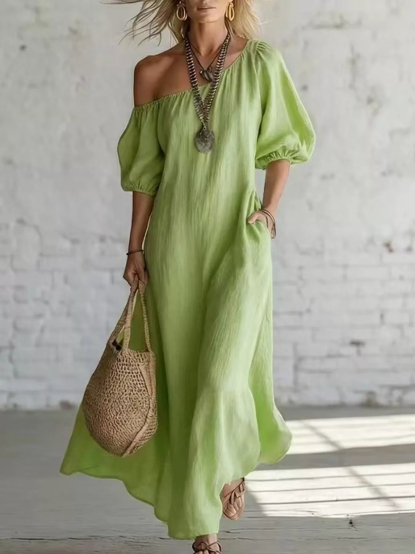 Green one-shoulder maxi dress with puff sleeves and flowing draped skirt