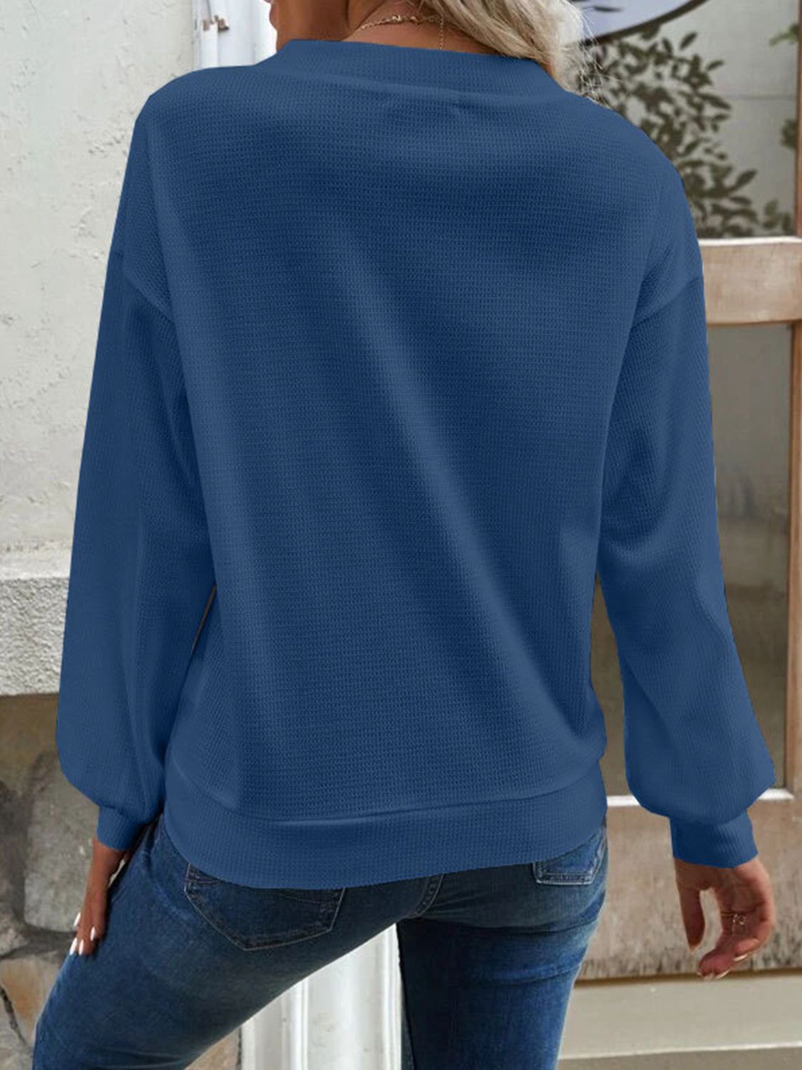 Blue V-neck blouse back view with long sleeves and dropped-shoulder fit