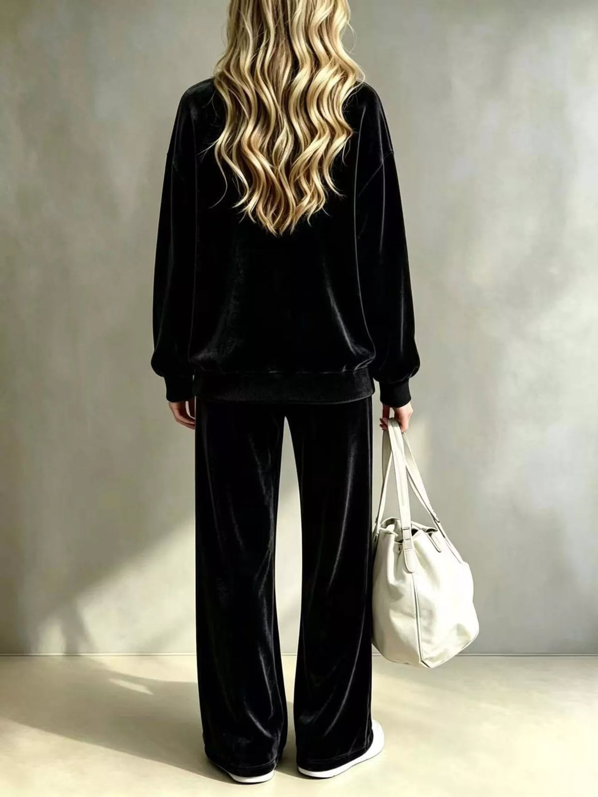 Black velvet two-piece set with long-sleeve pullover top and matching wide-leg pants