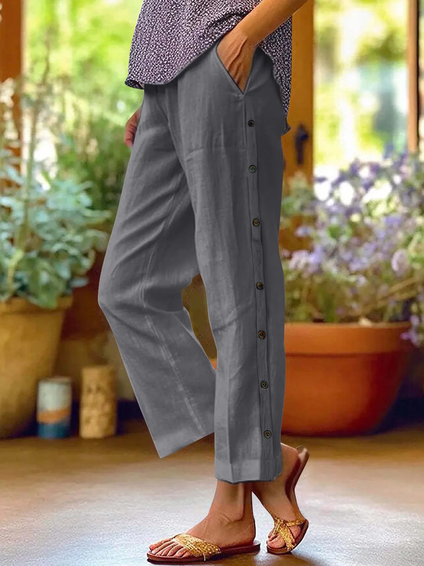 Dark gray wide-leg pants with side buttons and an easy, relaxed drape