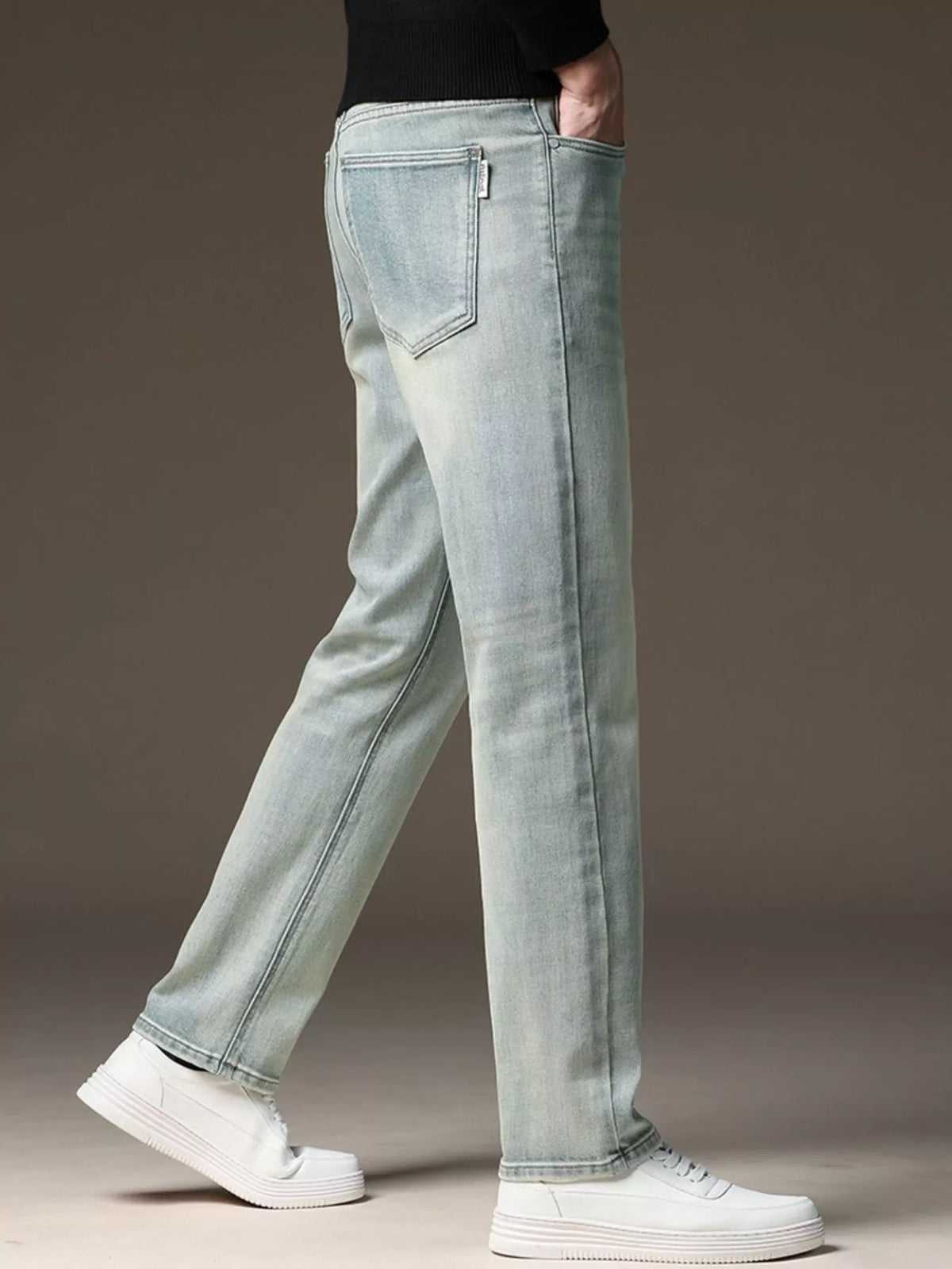 Light wash straight-leg jeans with back patch pockets and zip fly