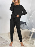 Black long-sleeve lounge top with drawstring waist jogger pants, full length view