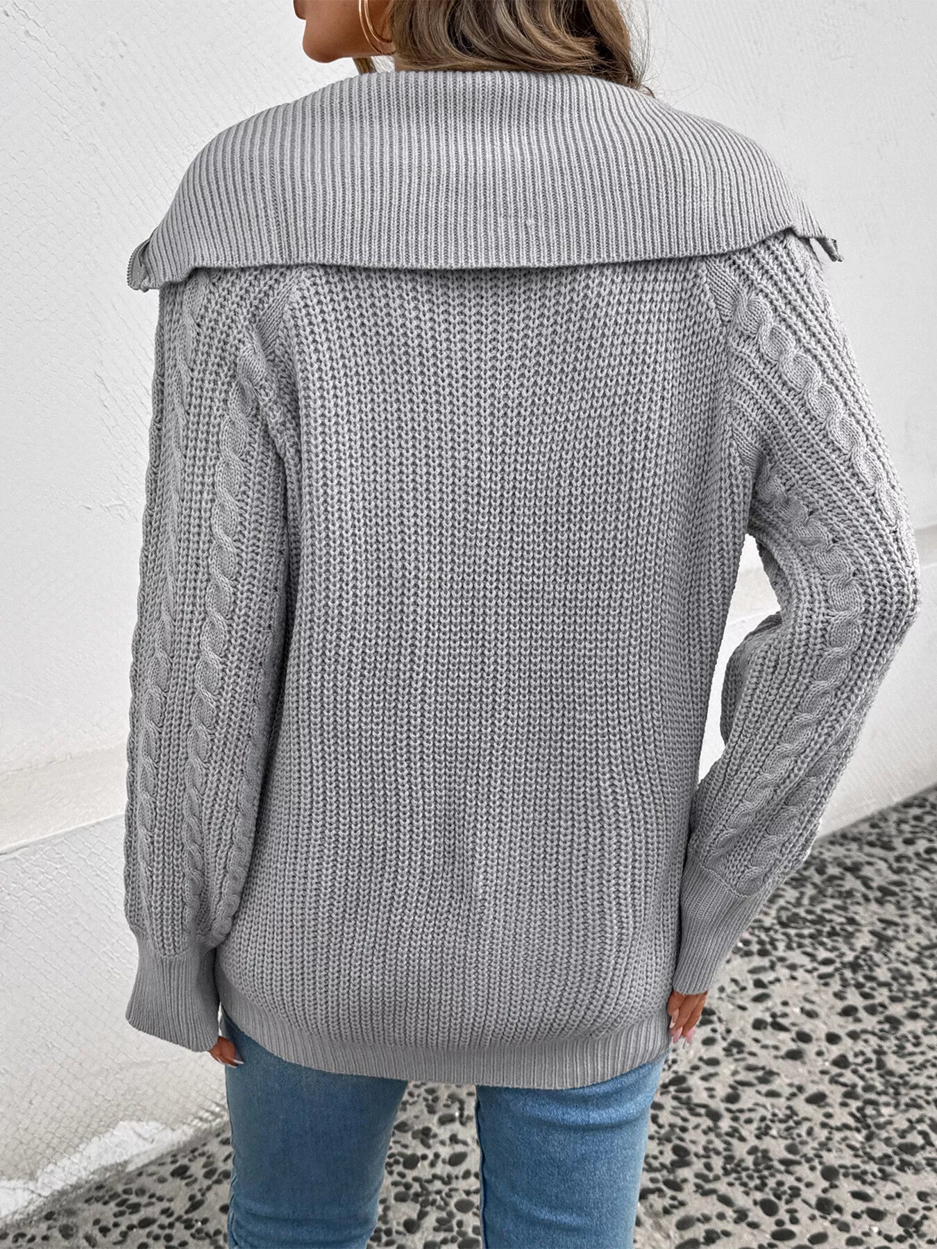 Gray cable knit half-zip sweater back view with ribbed yoke and cable sleeves