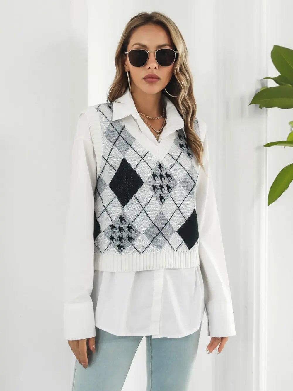 V-neck argyle plaid sweater vest in white with black diamond pattern, sleeveless knit