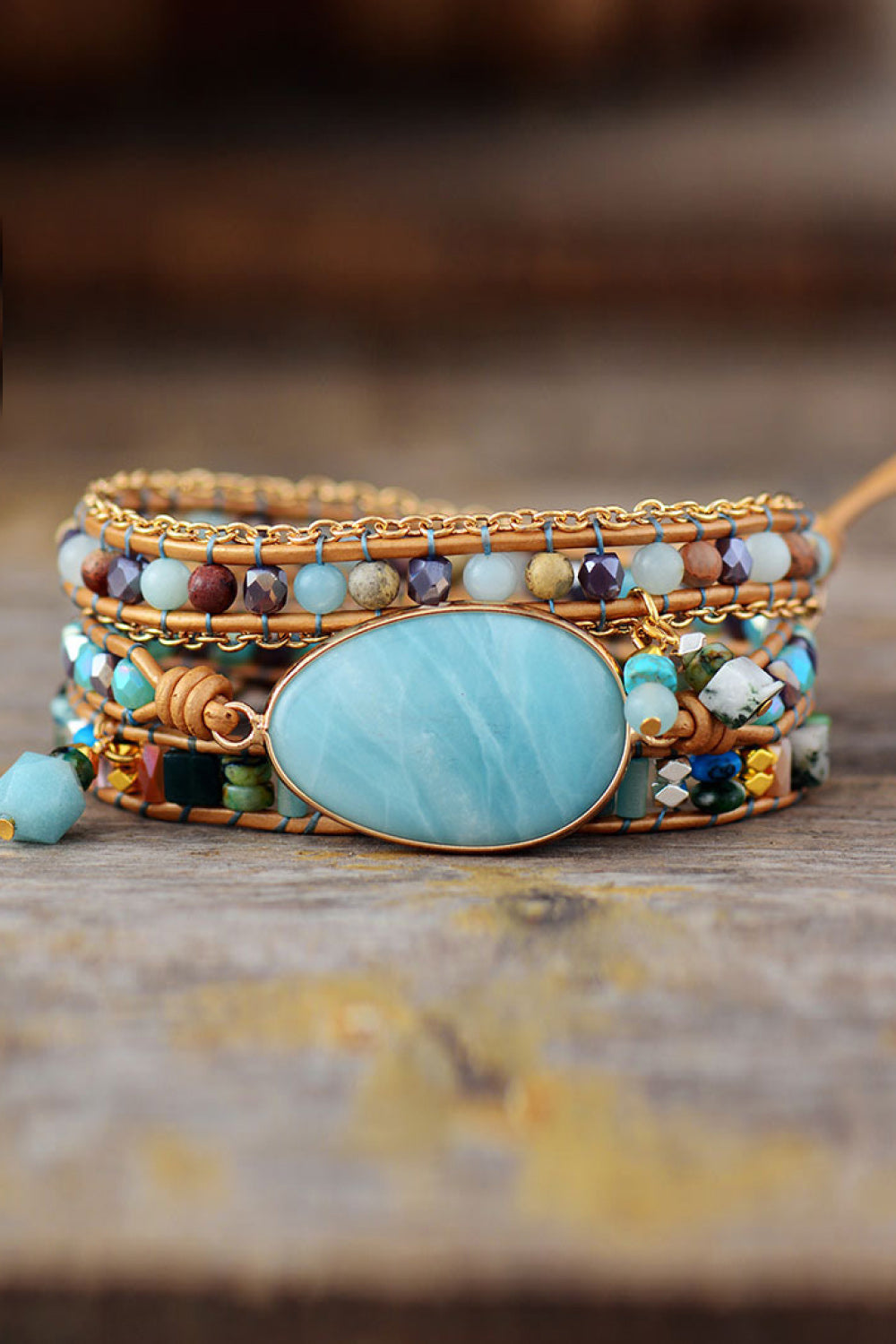 Triple-layer beaded bracelet with aqua oval center bezel and bronze-toned bead strands
