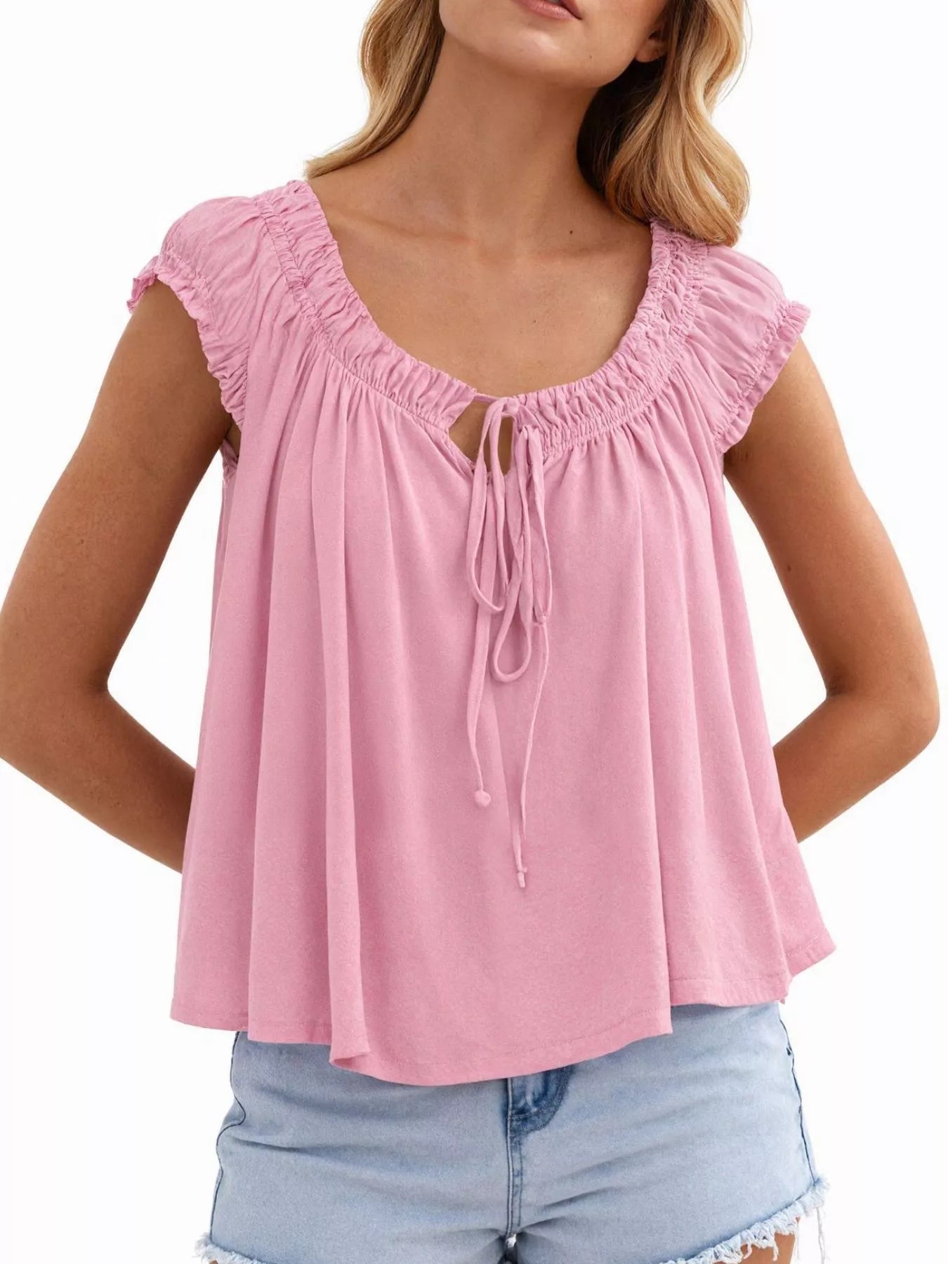Pink tie-front blouse with ruffled cap sleeves and center drawstring tie at neckline