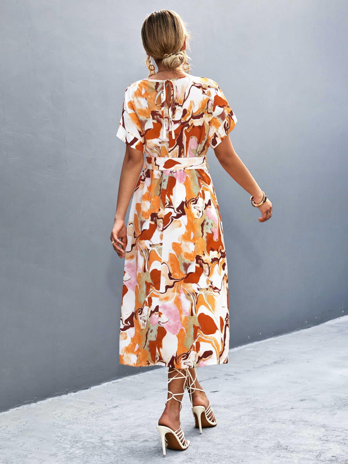 Orange, pink, and white abstract print midi dress with round neck, short sleeves, tie waist