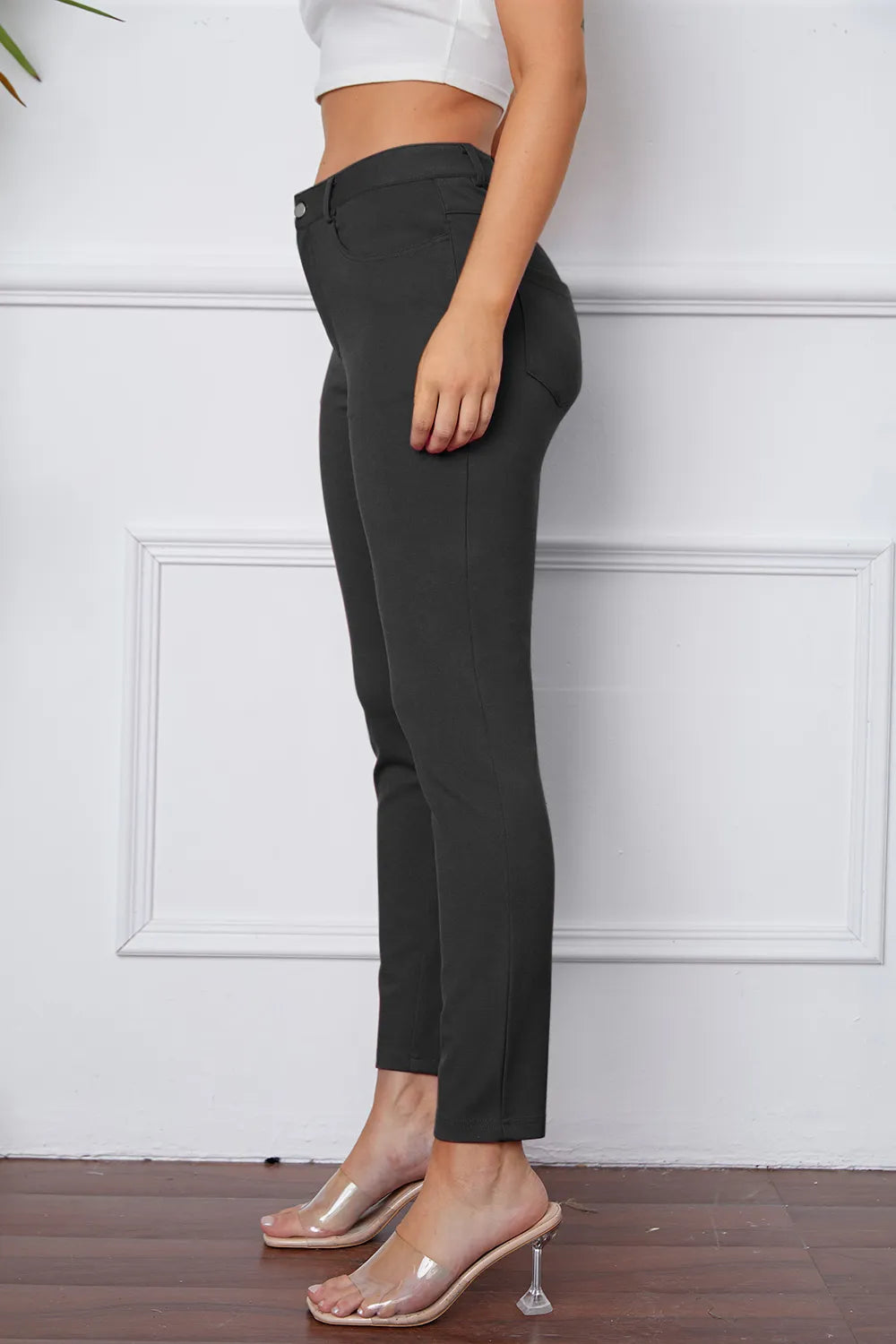 Black slim ankle pants with belt loops, button front, and side pockets