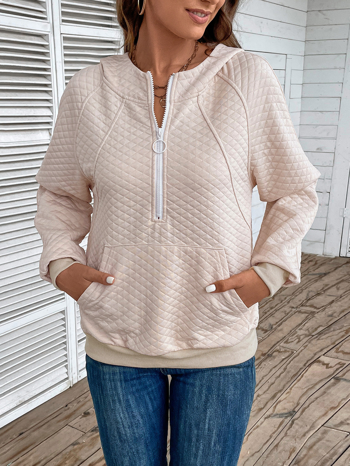 Cream quilted half-zip hoodie with hood and kangaroo pocket, long sleeves