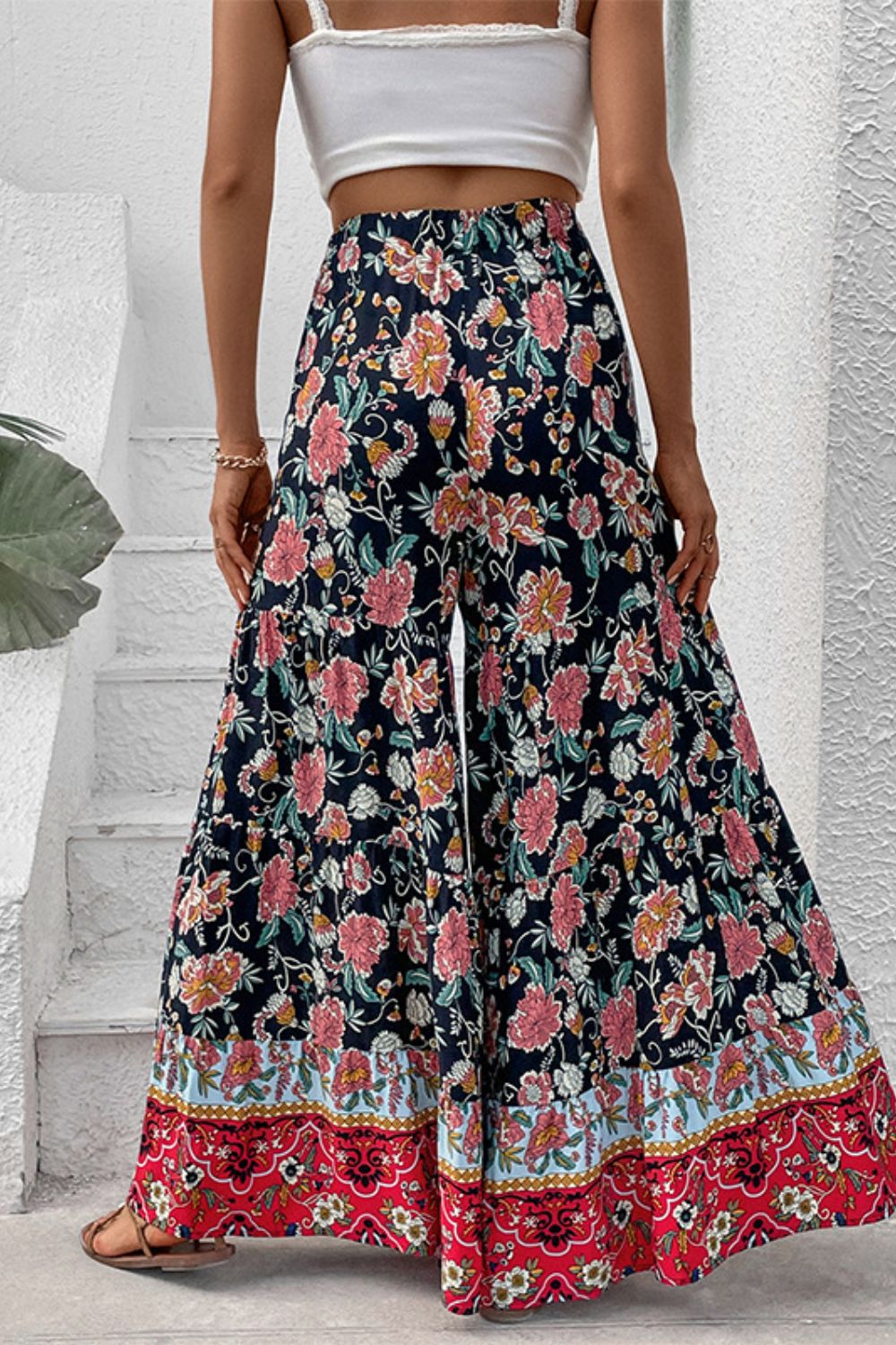 Floral high-waist palazzo pants, dark base with pink flowers and red border at hem