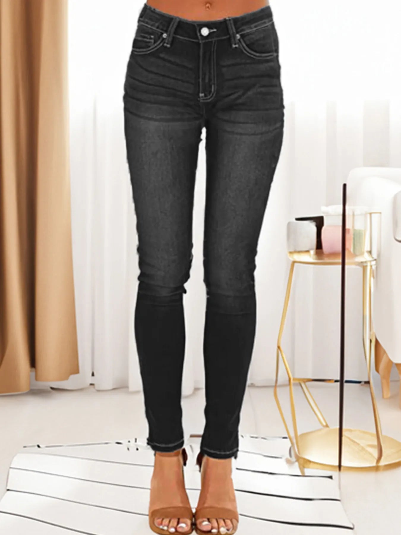 Black skinny fit washed jeans with five-pocket styling and button-and-zip fly.