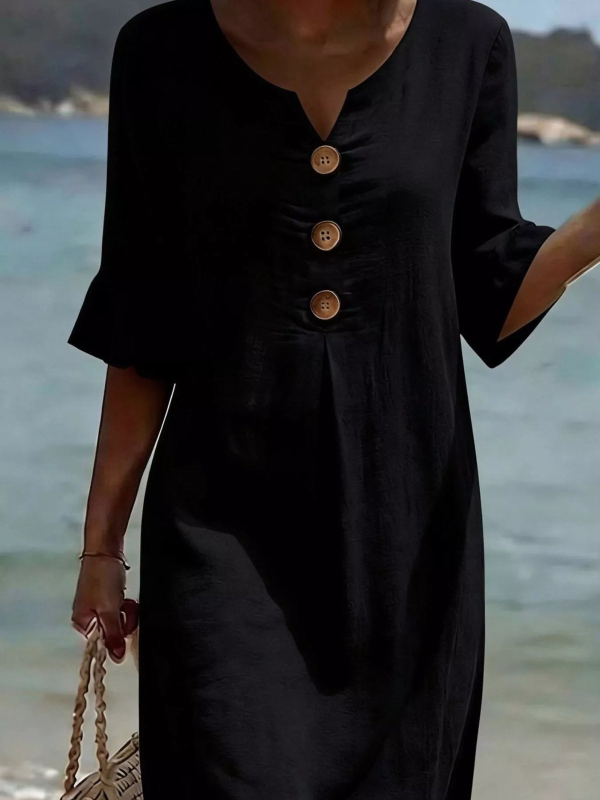 Black button-front dress with half sleeves and ruffled cuff details