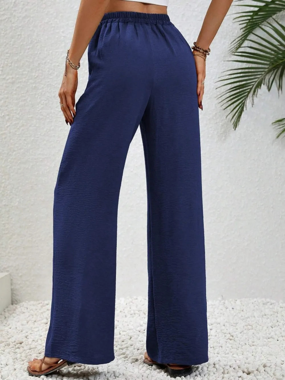 Dark blue wide-leg drawstring pants with elastic waist and relaxed wide fit