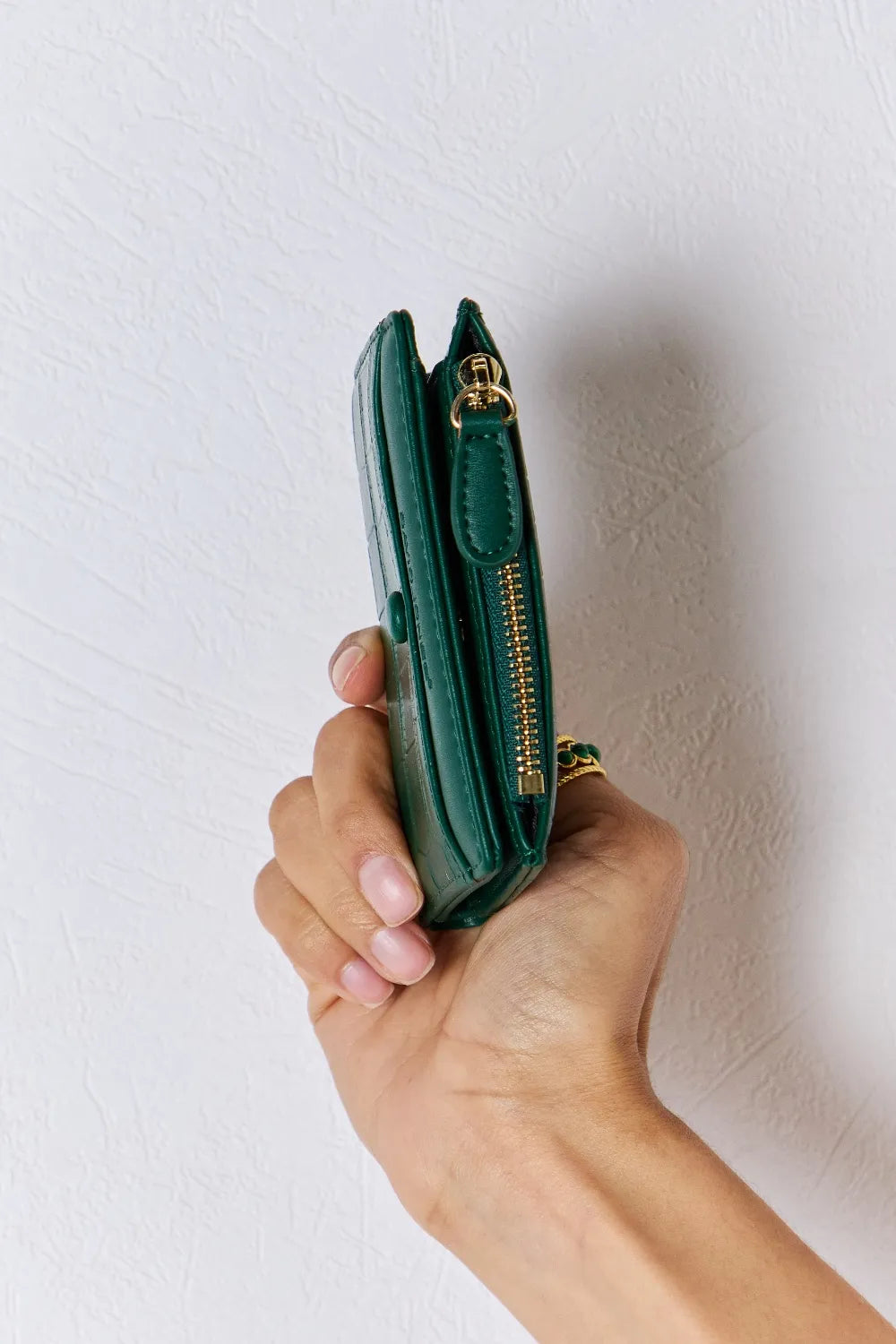 Green textured vegan leather mini wallet side view with gold-tone zipper