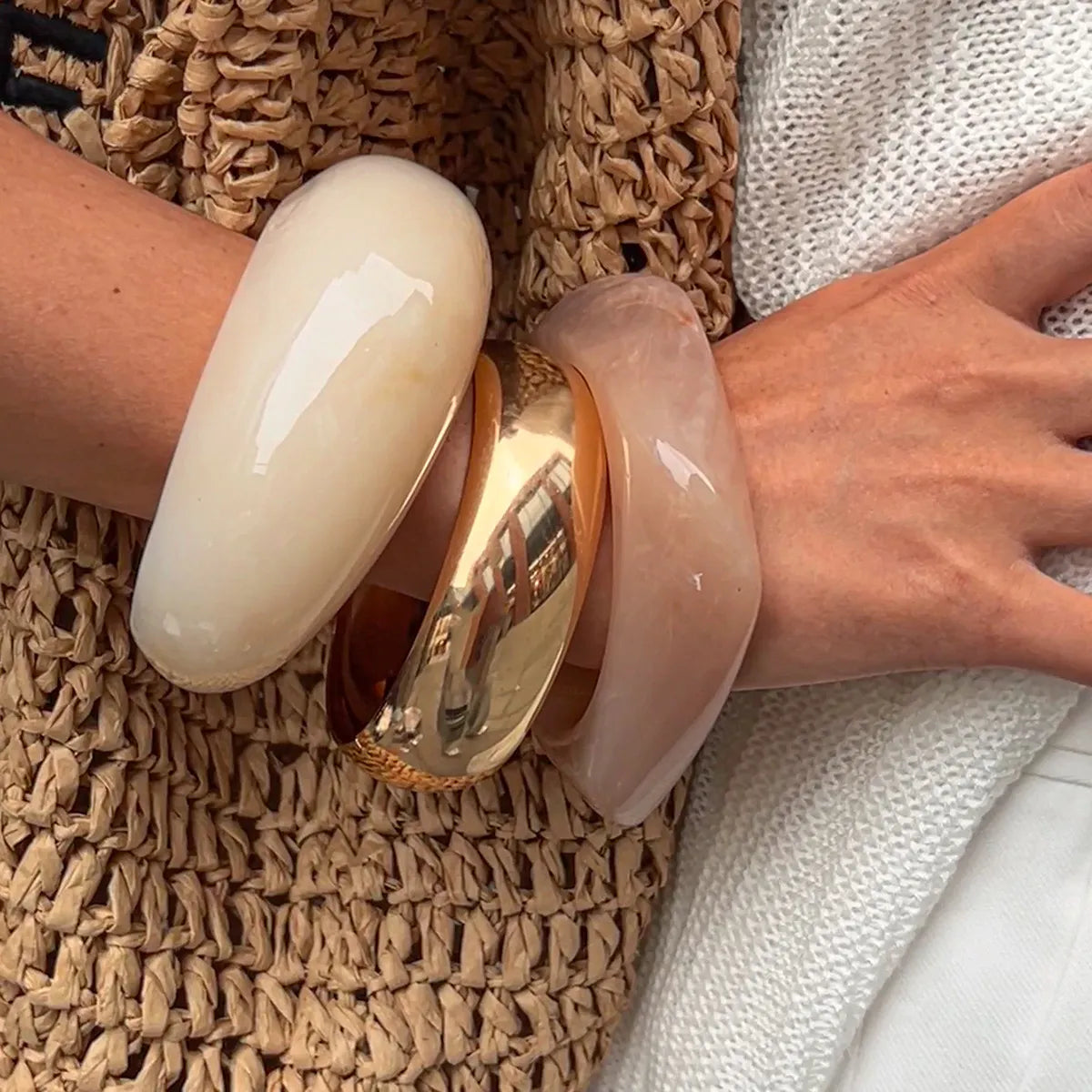 Chunky resin bangles set: cream and blush cuffs with gold-tone ring detail
