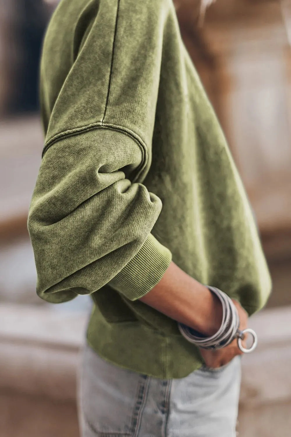 Moss green sweatshirt sleeve with ribbed cuff, dropped-shoulder design