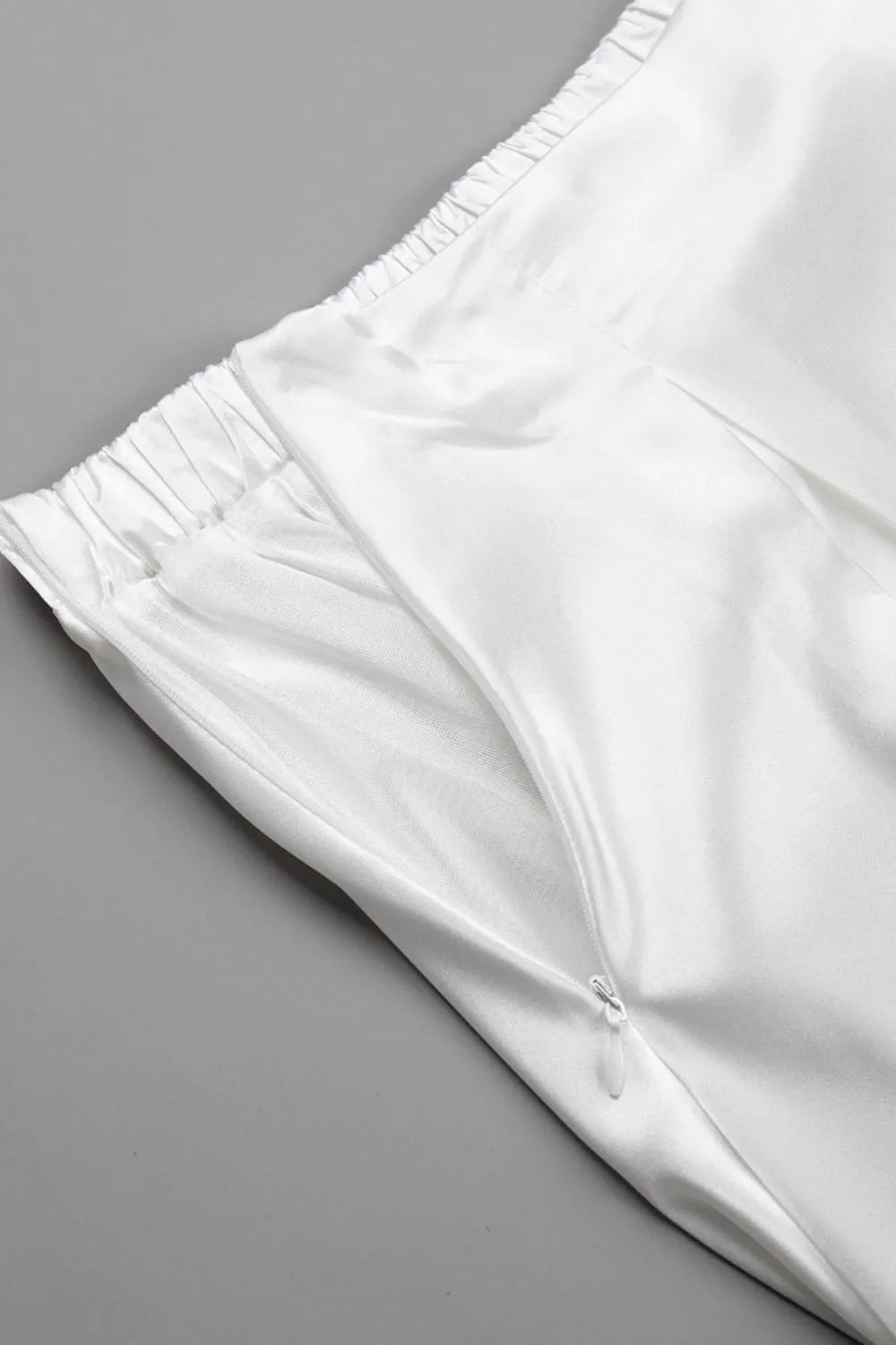 White satin skirt with back elastic waistband and gathered fabric, button at back