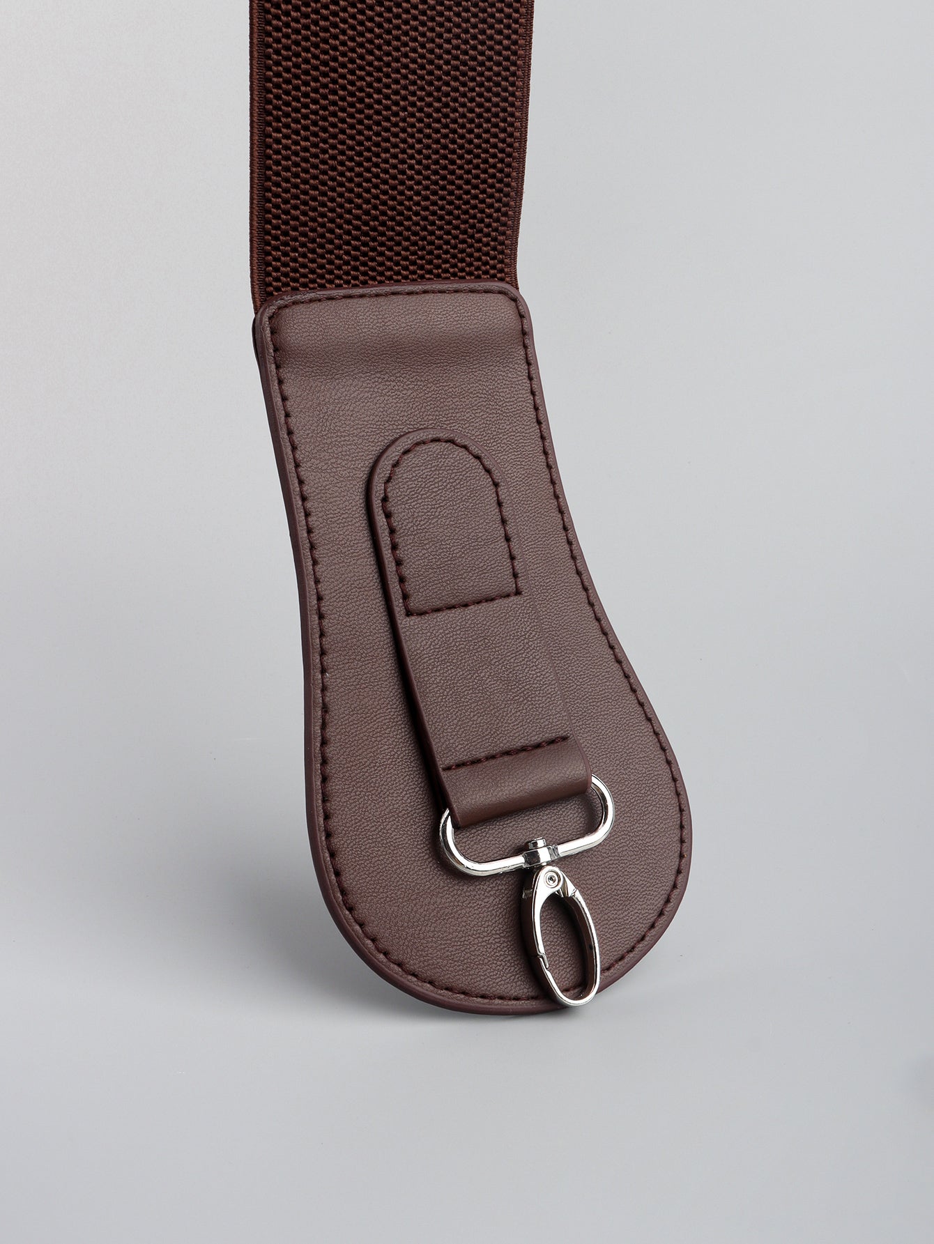 Caramel brown elastic vegan leather belt end with D-ring and stitched rectangular patch