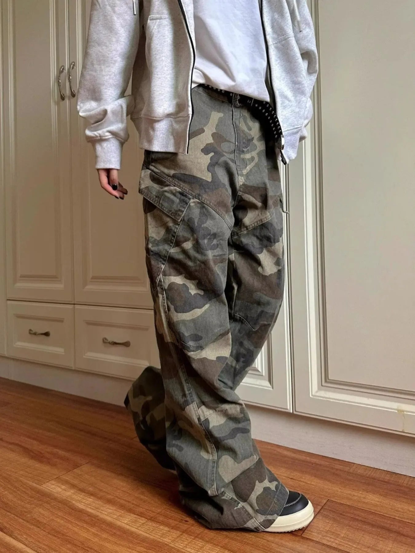 Green camouflage cargo jeans with large cargo pockets and cuffed hem