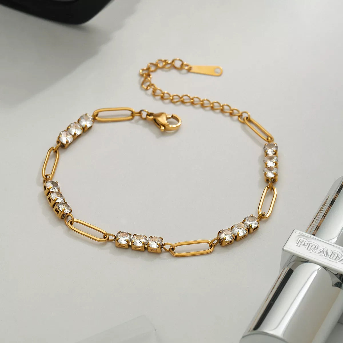 Gold-plated rhinestone chain bracelet with oval link details and clasp