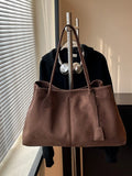 Brown suede tote bag with dual top handles and front flap pocket