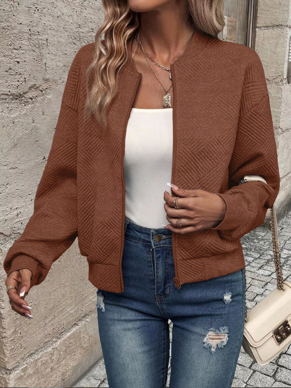 Brown textured knit zip-up jacket with long sleeves and front pockets