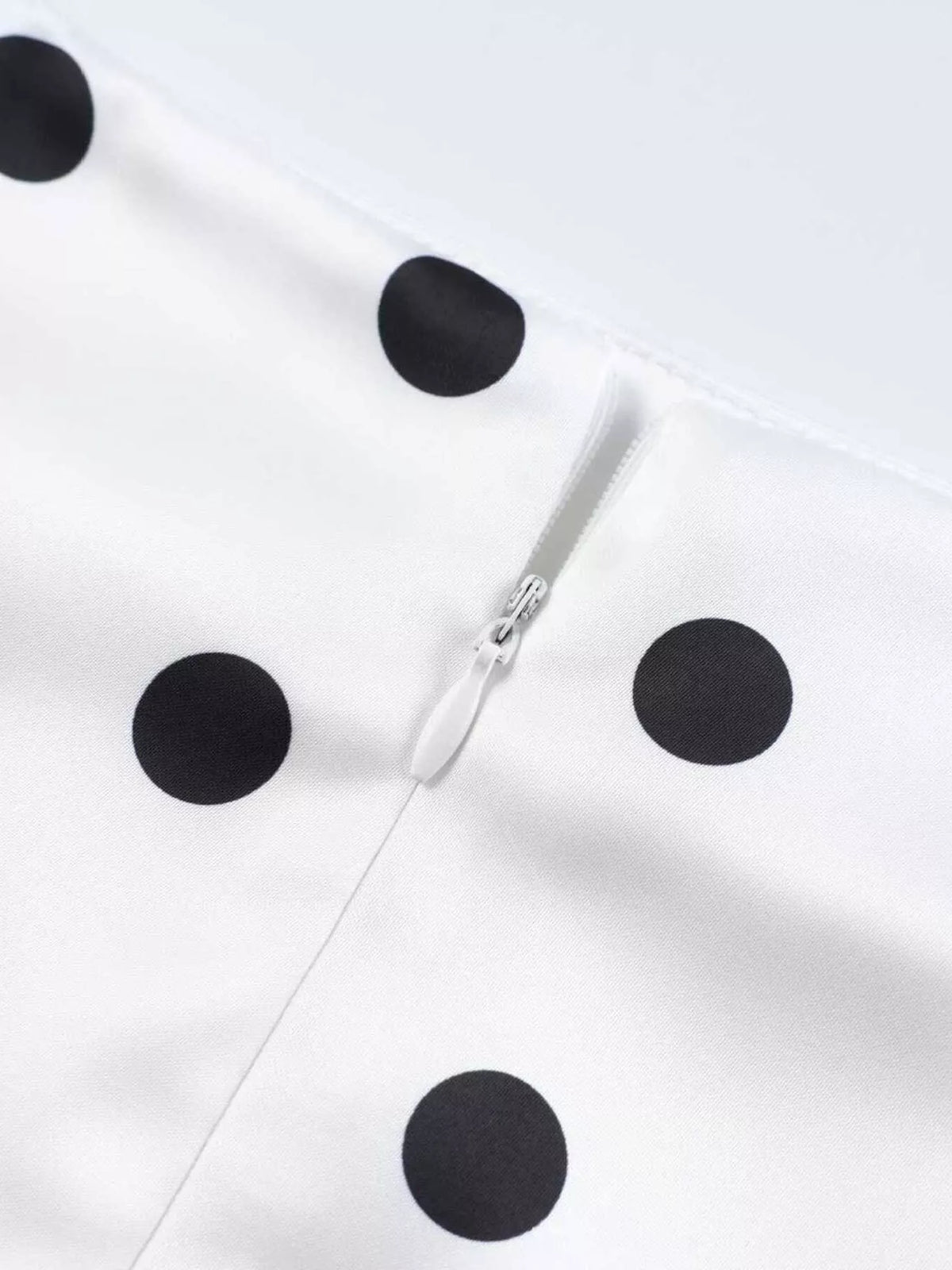 White polka dot skirt with visible back zipper seam