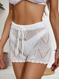 White crochet swim shorts with drawstring tie, cutout pattern, elastic waist, scalloped hem