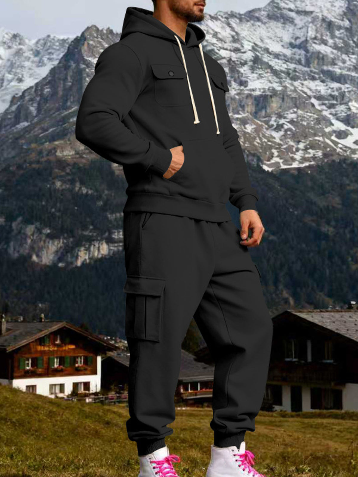 Two-piece kangaroo hoodie set: black hoodie and black cargo sweatpants, standing side view
