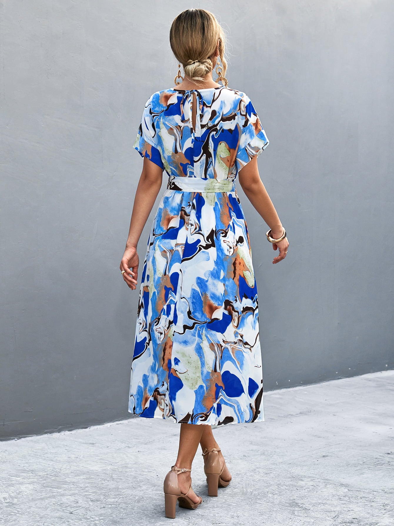 Blue abstract midi tie-waist dress, back view with short sleeves and round neck