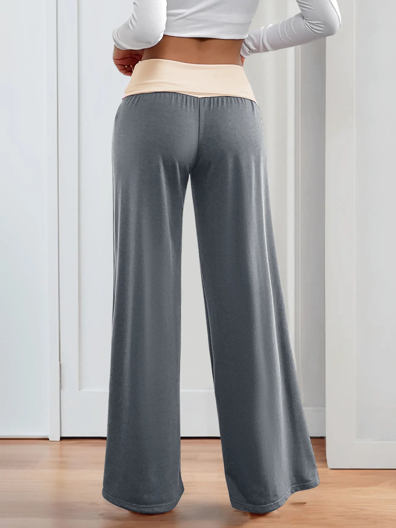Dusty blue wide-leg pants with elastic waist and contrast cream waistband, back view