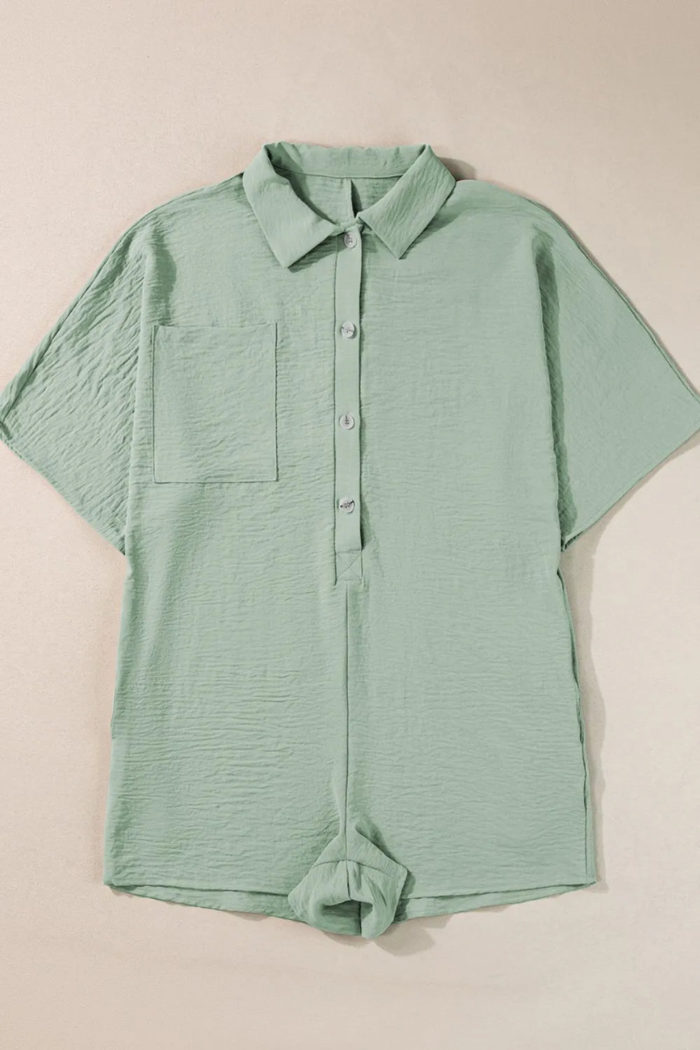 Sage collared romper on hanger with front buttons and short sleeves