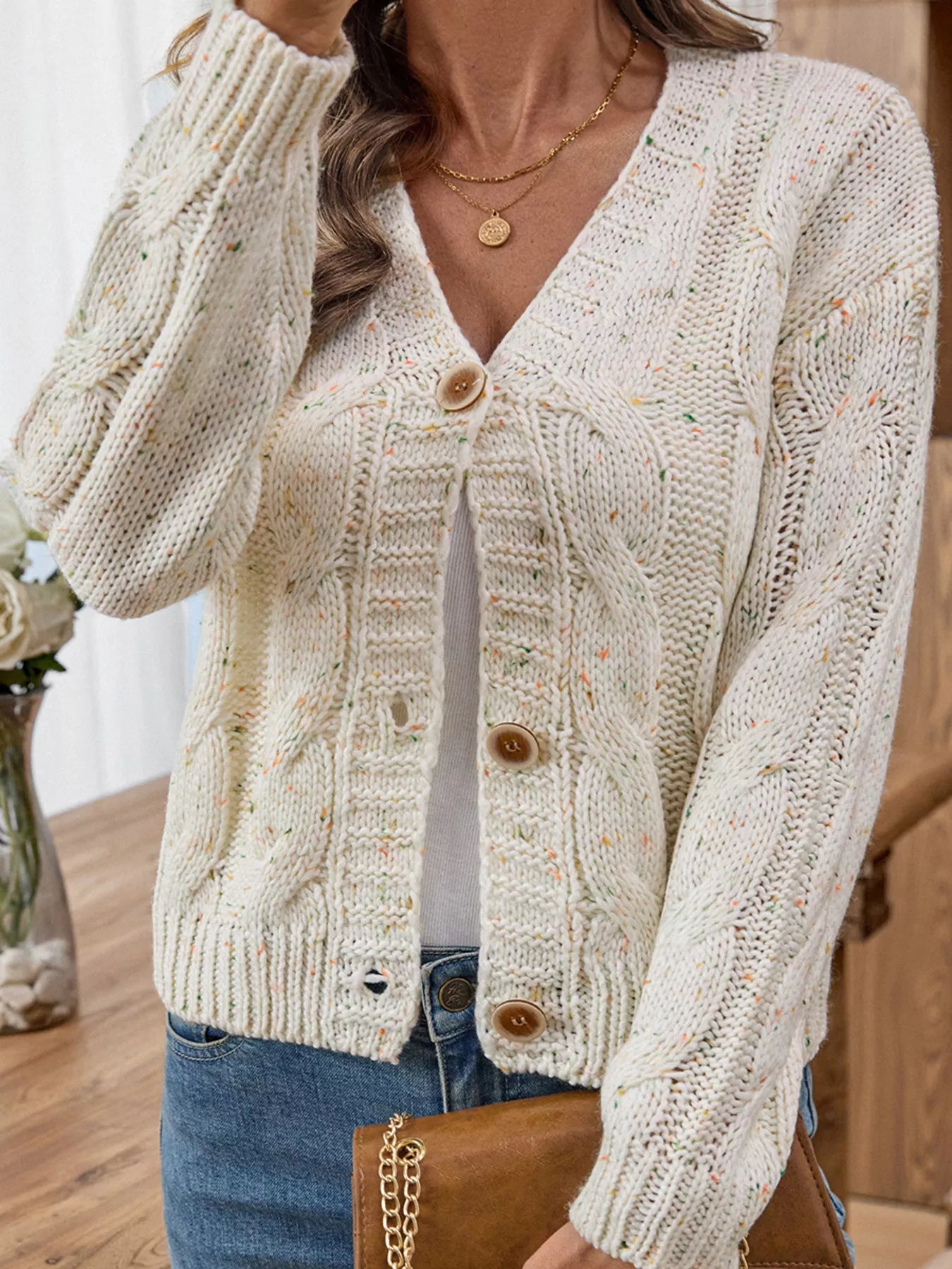 Beige cable knit V-neck cardigan with wood-tone buttons and long sleeves