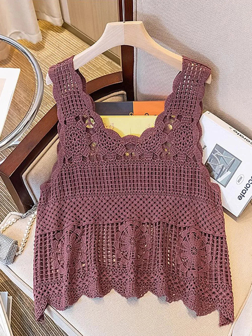 Mauve openwork scoop-neck tank on hanger with lace-like yoke and layered scallops