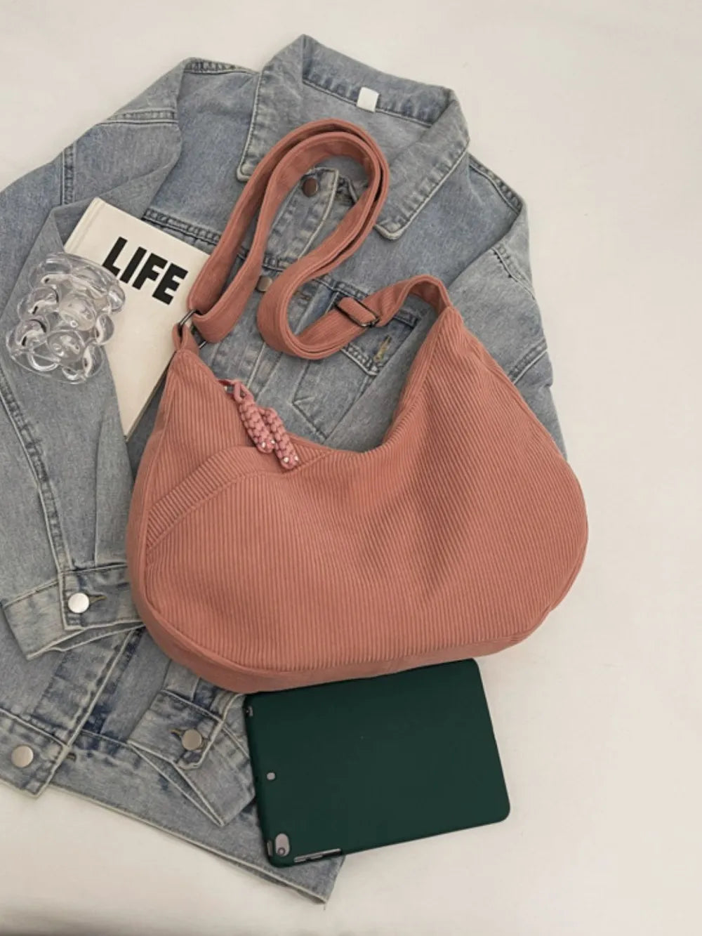Dusty rose ribbed shoulder bag with adjustable strap and drawstring top