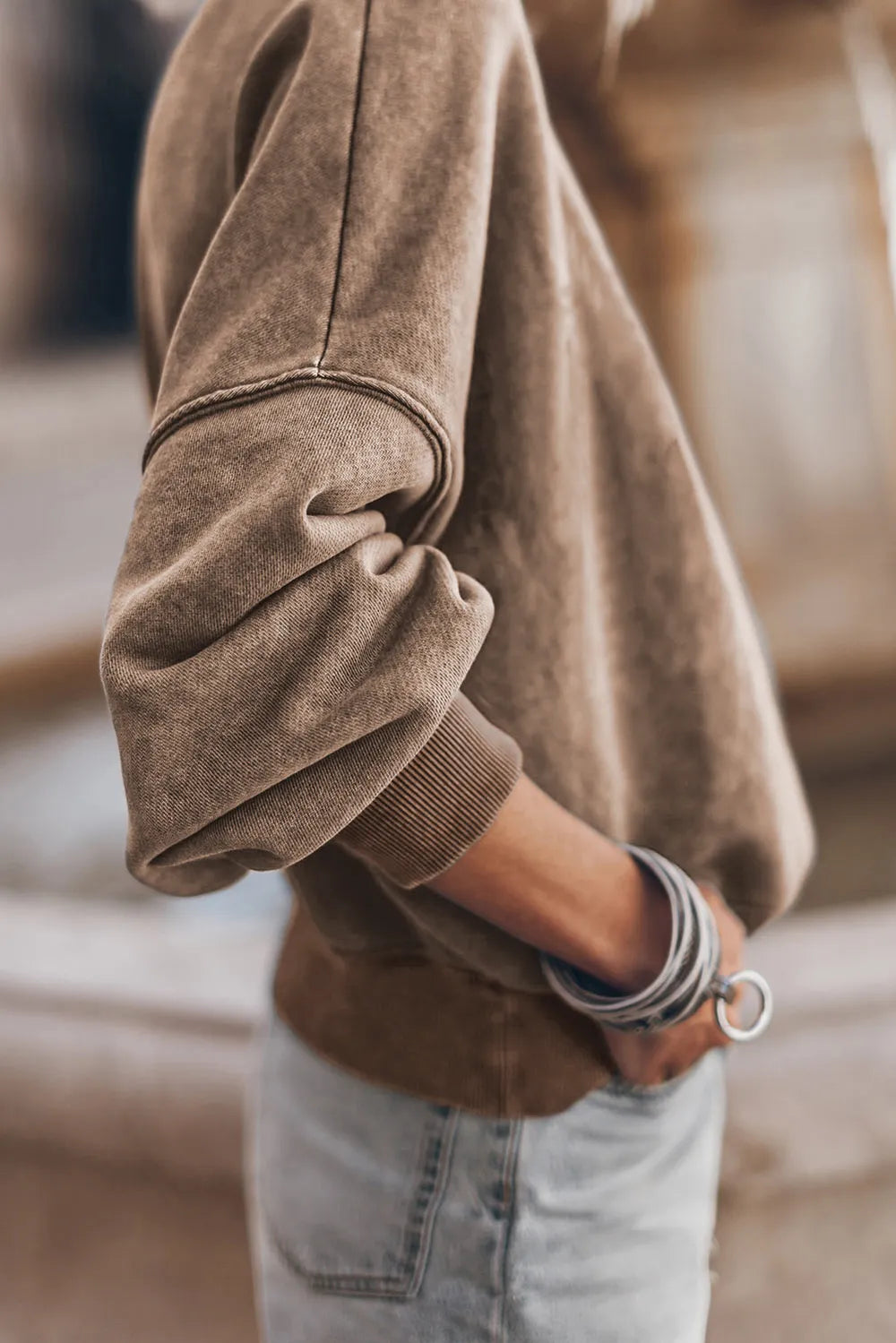 Taupe sweatshirt sleeve with ribbed cuff and dropped-shoulder seam