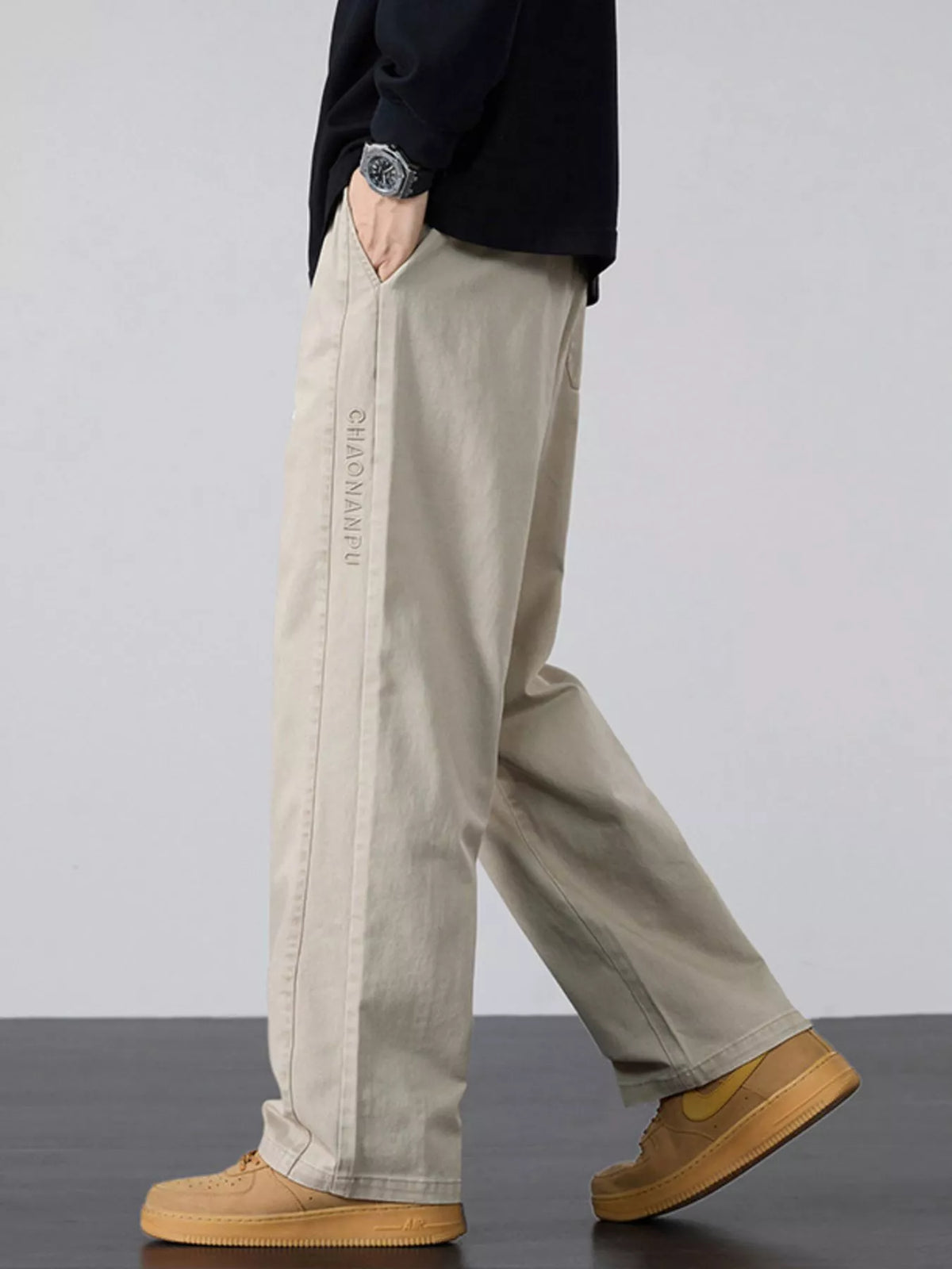 Men's wide-leg drawstring casual pants in light khaki, relaxed straight-leg style.